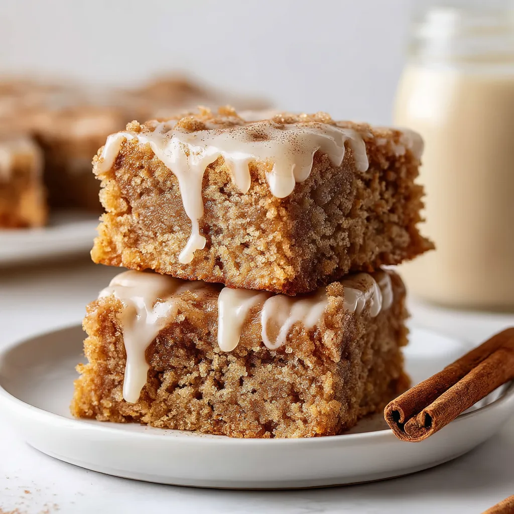 Plate of dessert topped with glaze and cinnamon.