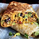 A delicious burrito with cheese and vegetables.