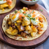 A delicious Mexican meal with a variety of ingredients, including eggs, potatoes, and cheese.